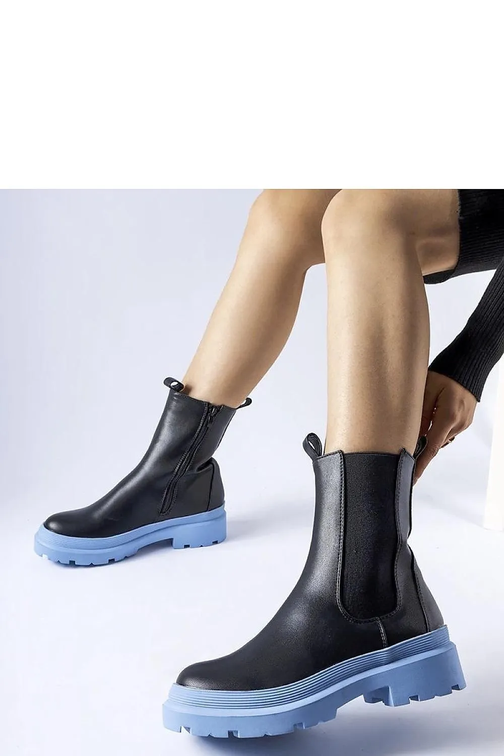 Black ankle boots with an olive sole