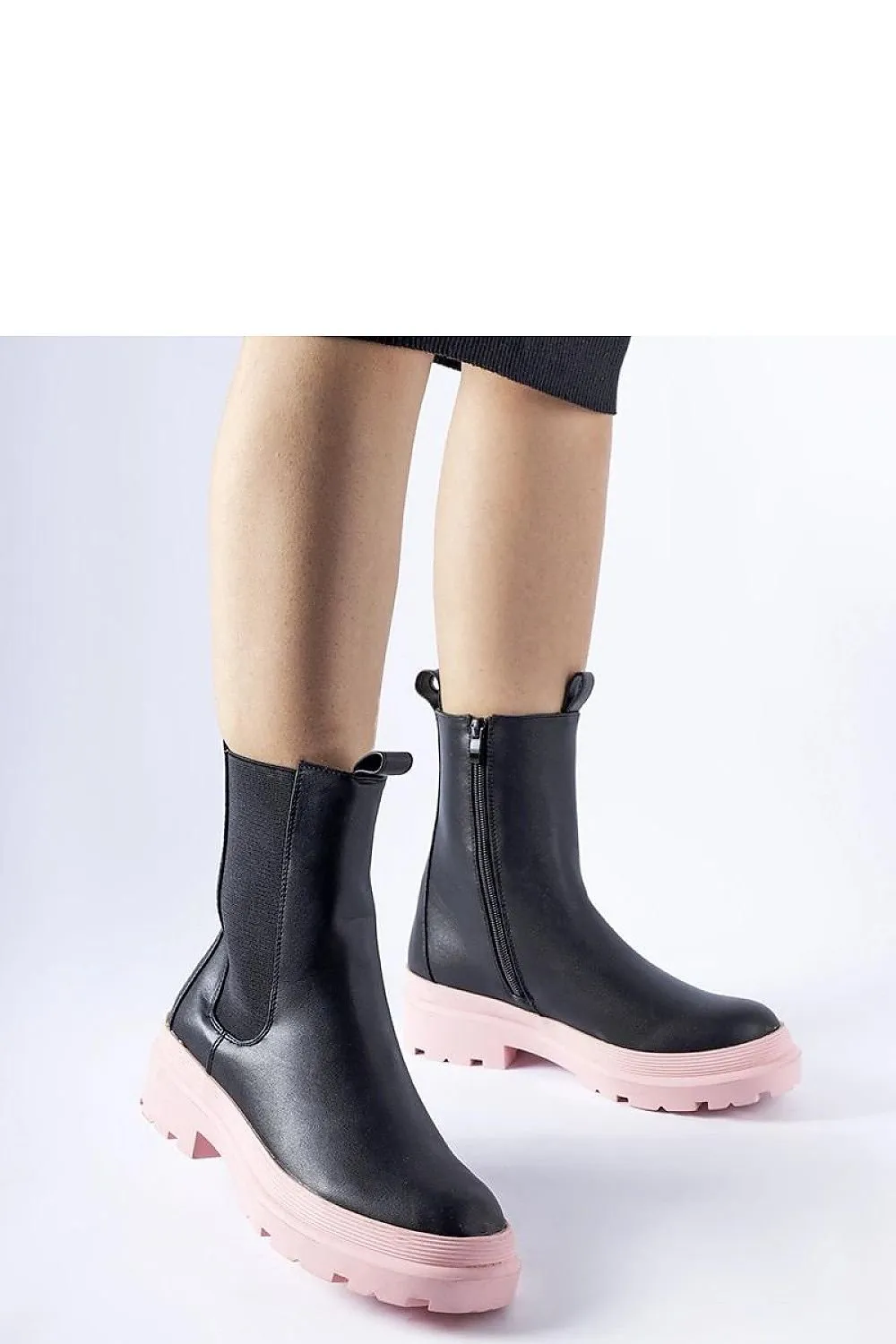 Black ankle boots with an olive sole