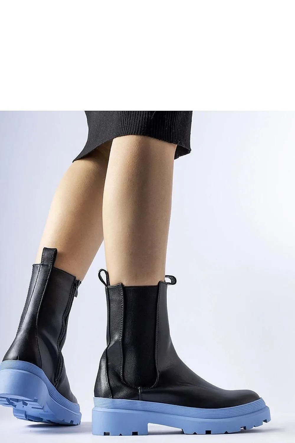 Black ankle boots with an olive sole