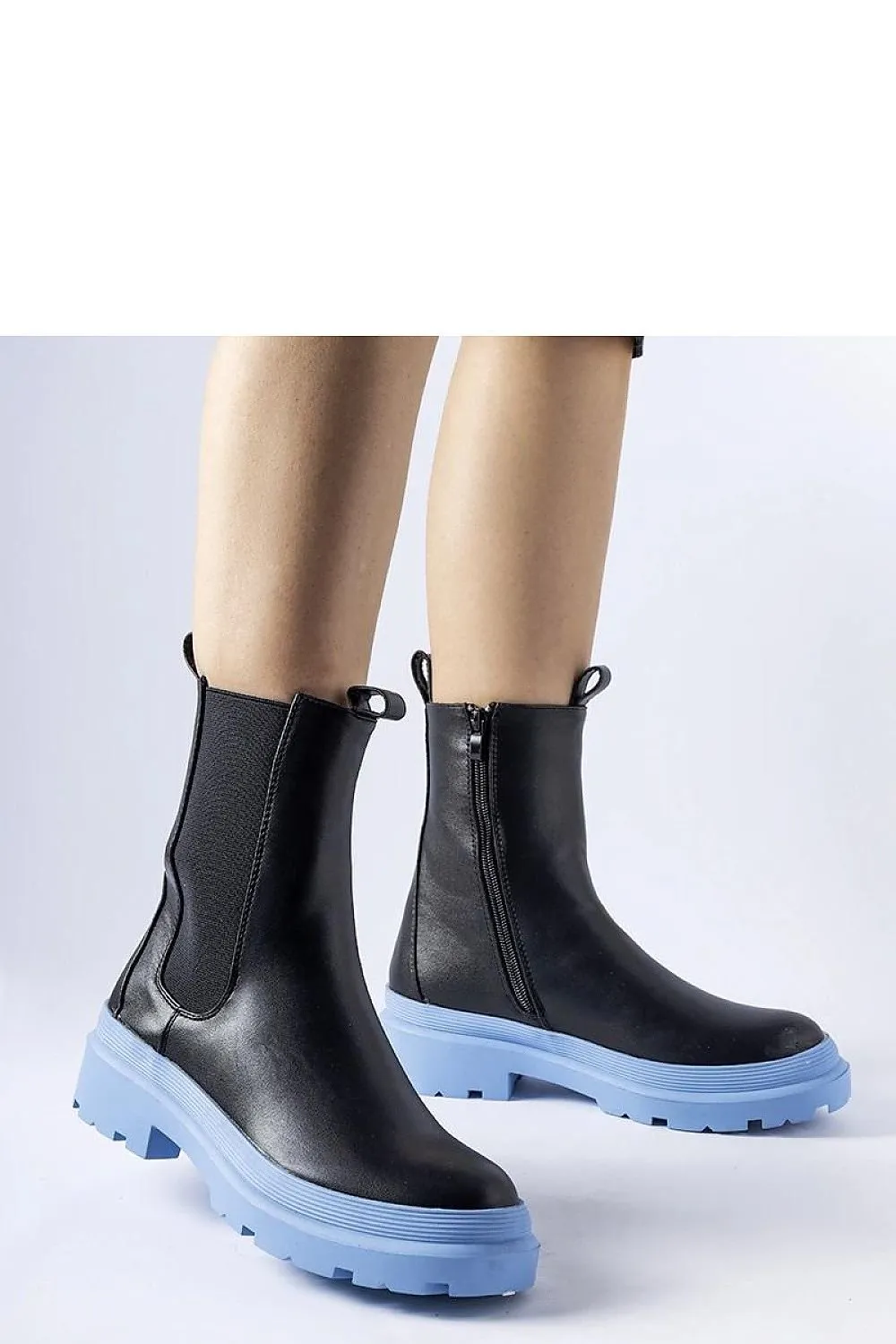 Black ankle boots with an olive sole
