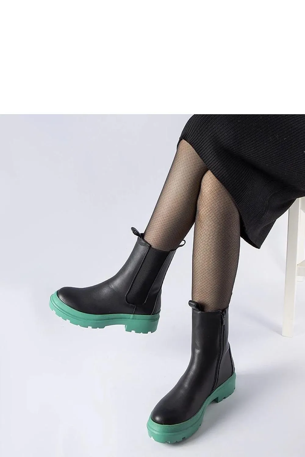 Black ankle boots with an olive sole