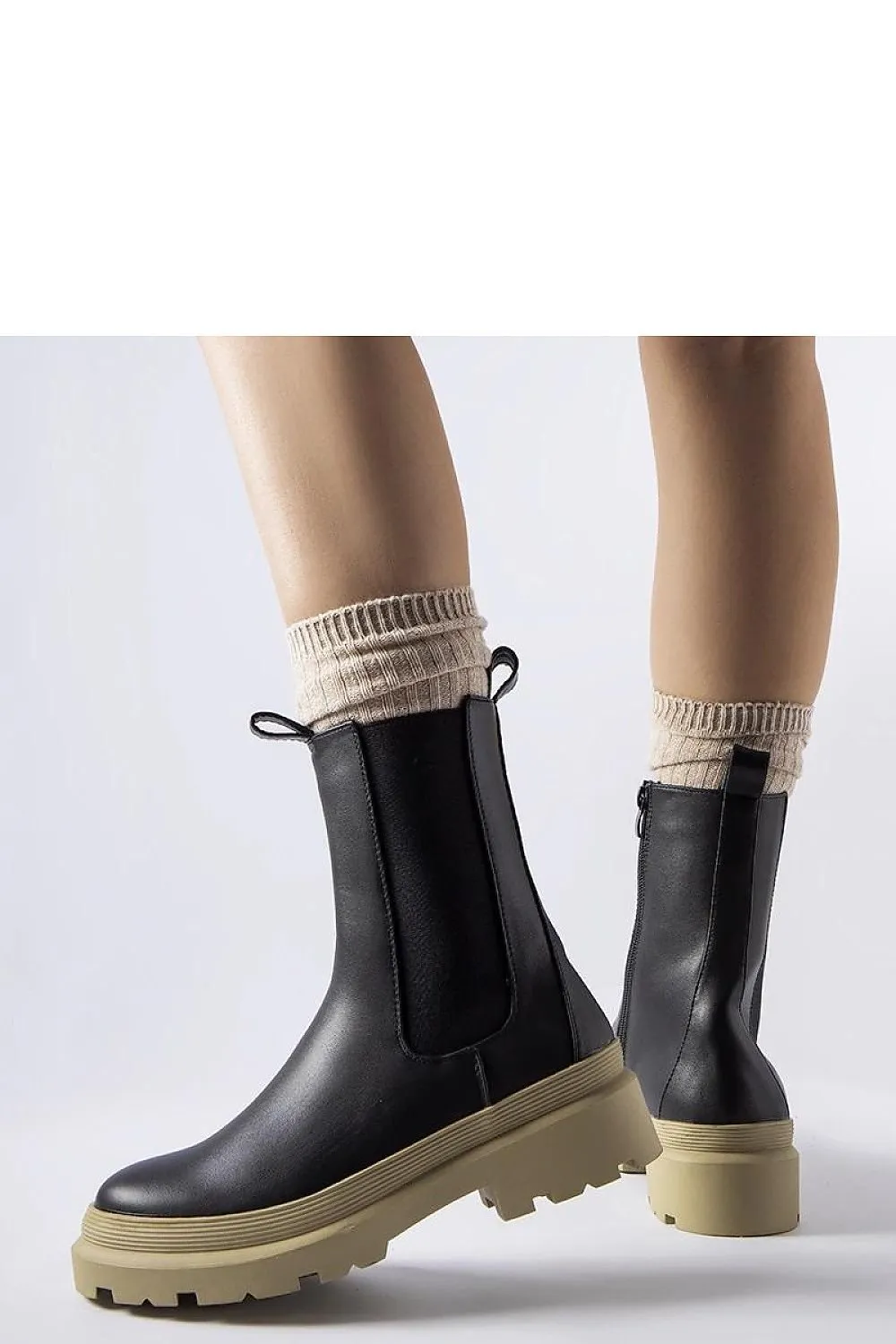 Black ankle boots with an olive sole