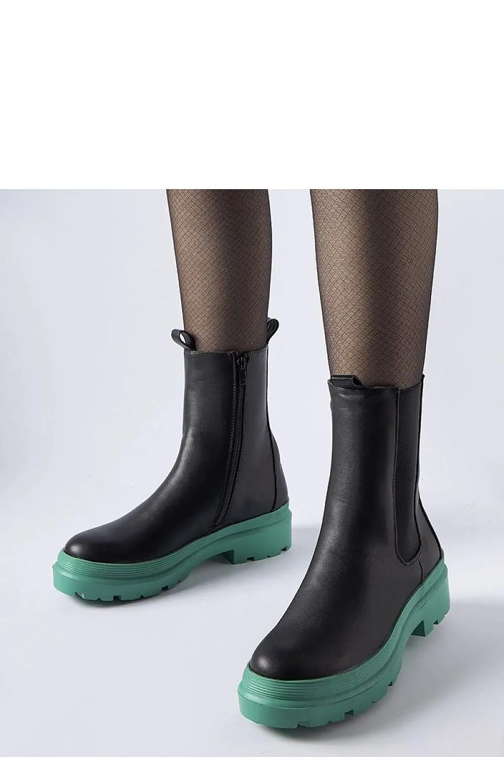 Black ankle boots with an olive sole