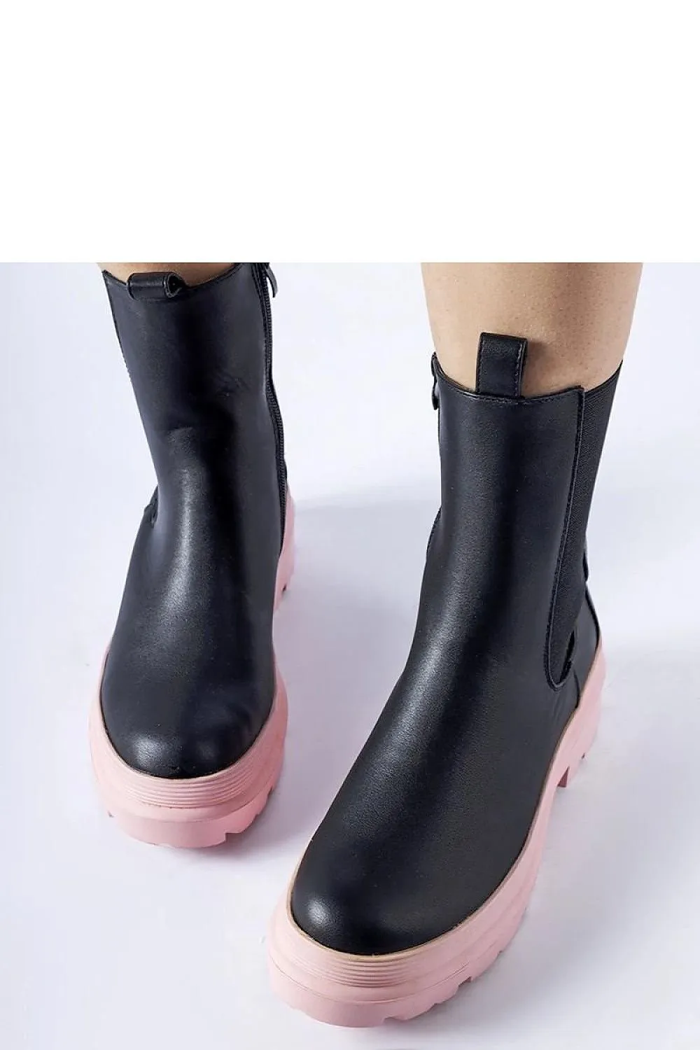 Black ankle boots with an olive sole