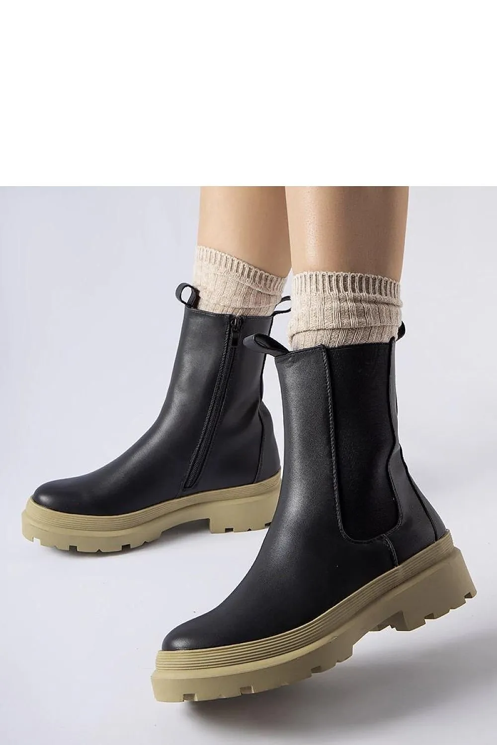 Black ankle boots with an olive sole